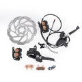 Arctic Leopard XE Pro R hydraulic brake components laid out: disc rotor, calipers, master cylinders with levers, brake lines, pads and mounting bolts
