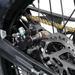 Rear hydraulic brake caliper and disc on the Arctic Leopard XE Pro R, with gold drive chain and swingarm